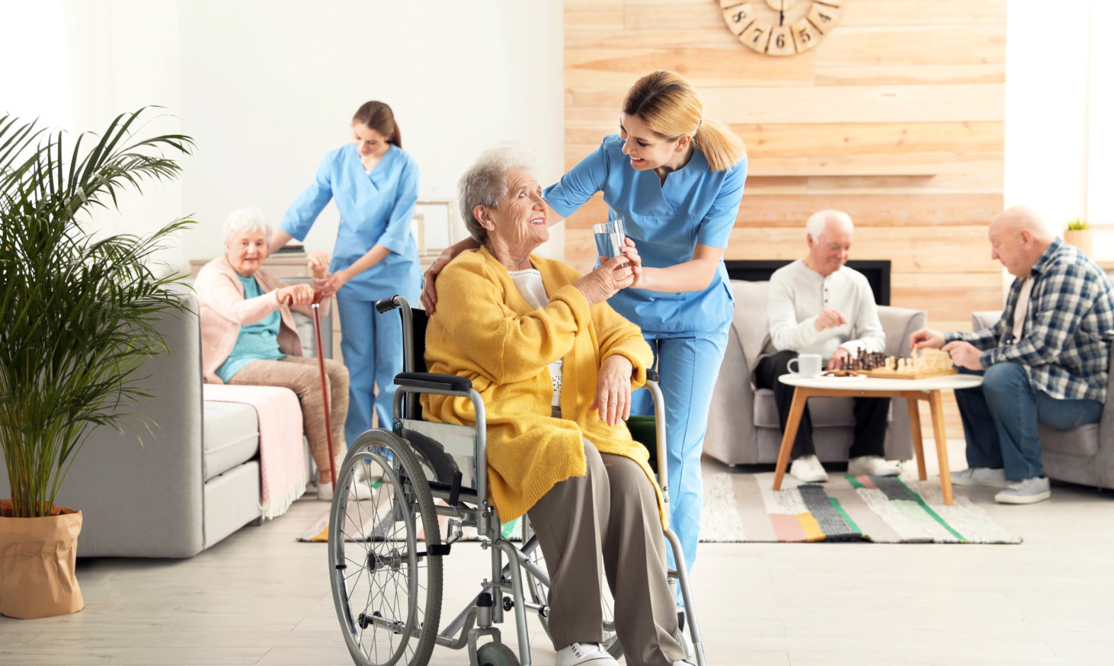 caregivers assisting senior men and women